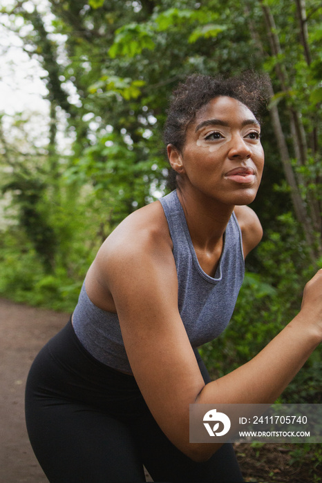 Happy young curvy woman with vitiligo working out in the park