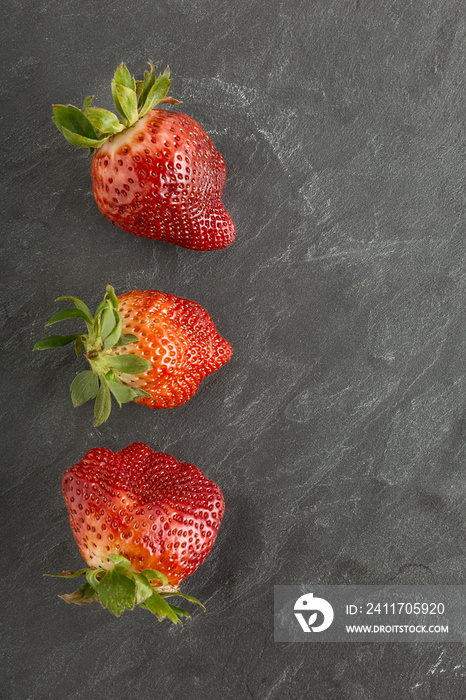 Ugly organic strawberries isolated on white background