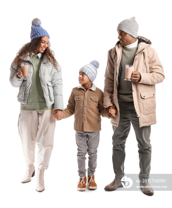 African-American family in winter clothes and with tasty hot chocolate on white background