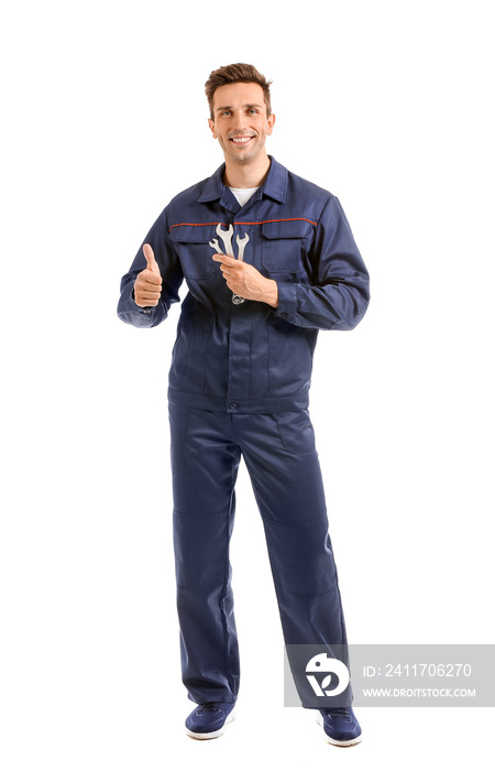 Male car mechanic showing thumb-up on white background