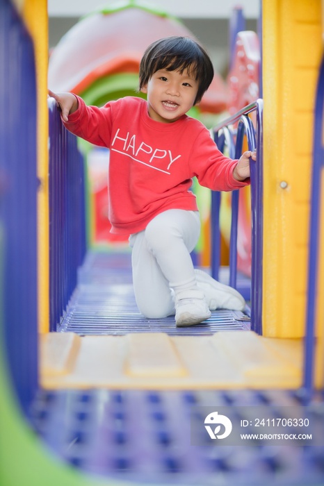 Child playing on outdoor playground.