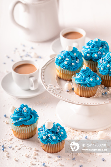 Tasty blue cupcakes served with coffee in white porcelain.