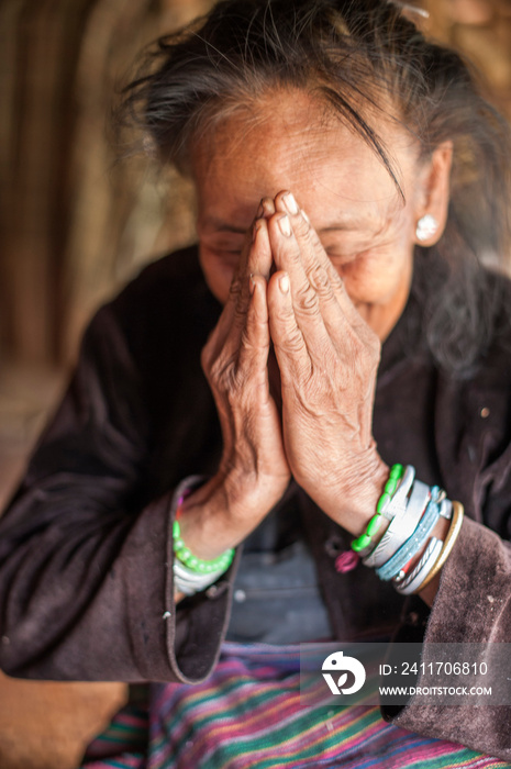 Senior woman with hands covering face, Shan State, Keng Tung, Burma