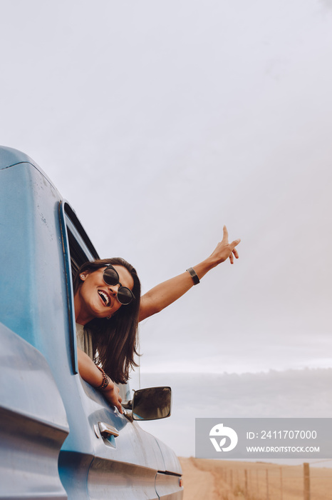 Beautiful woman enjoying traveling by car