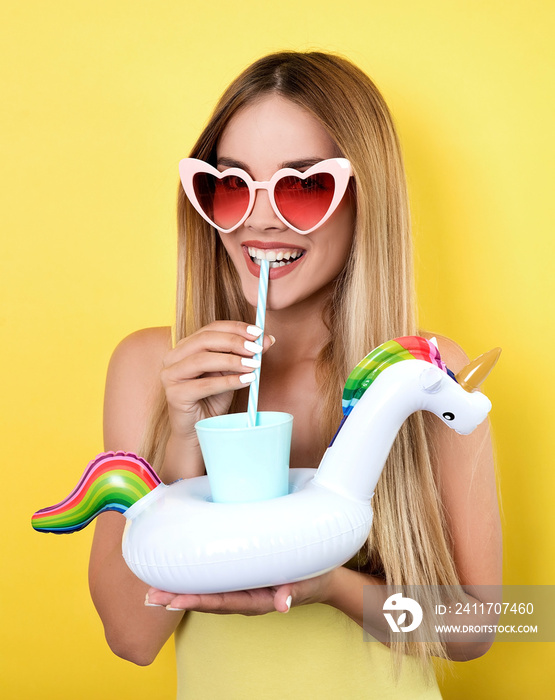 Young smiling woman drinking juice