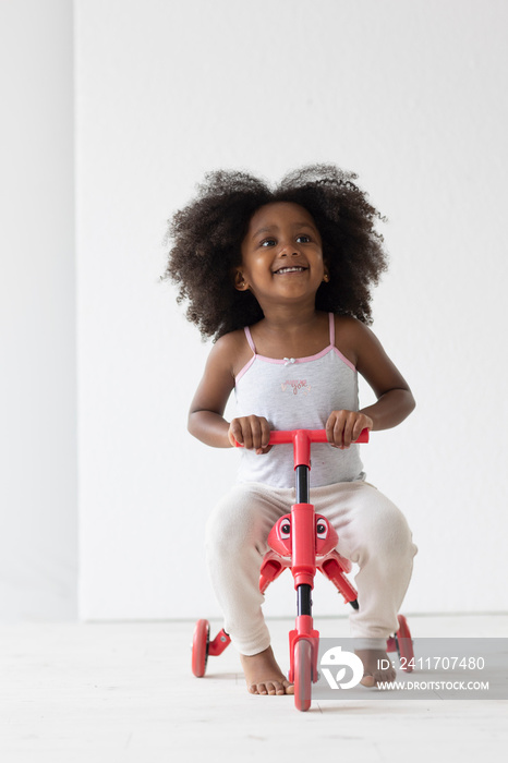 Portrait of girl riding on tricycle