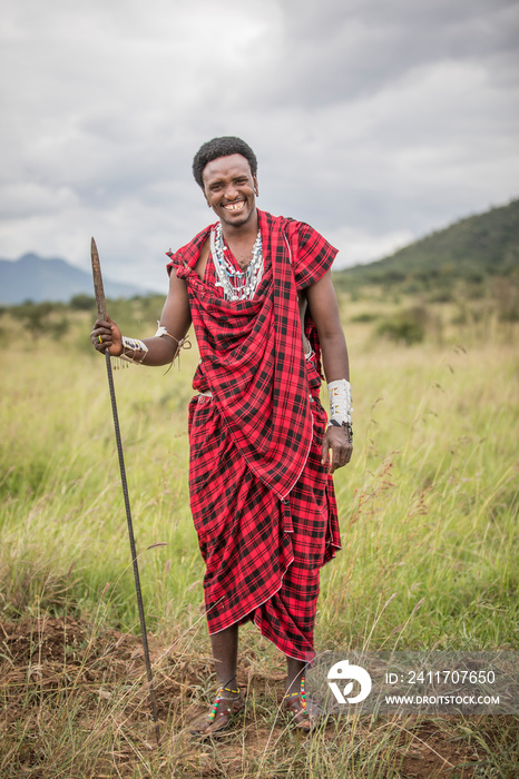 handsome maasai warrior in savannah