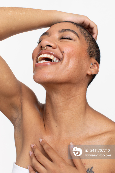 Studio portrait of smiling woman with eyes closed