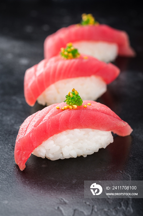 Three Sushi nigiri with tuna on black background