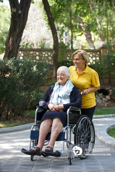 Careful caregiver taking care of the patient, outdoors.