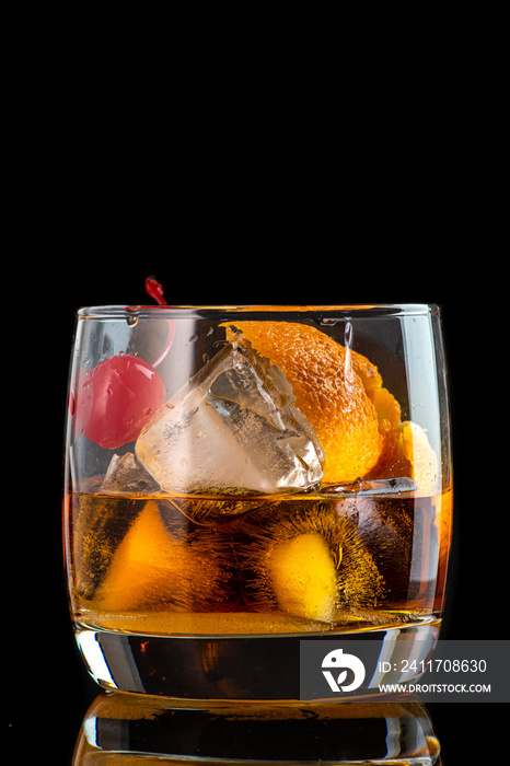 old fashion cocktail in a glass of rox on a black background