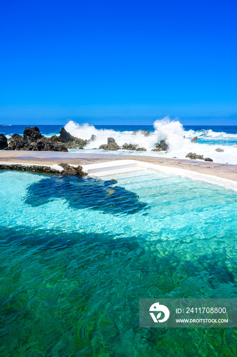 Natural volcanic swimming lagoon pools at Porto Moniz, travel destination for vacation, Madeira island, Portugal