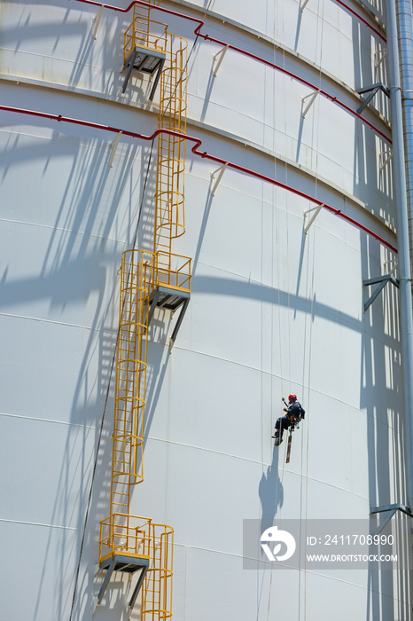 Male worker down height tank shell plate rope ladder  access safety inspection of thickness storage tank gas