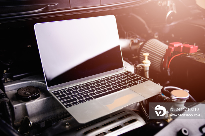 Professional car repair or maintenance mechanic engine working service with laptop computer