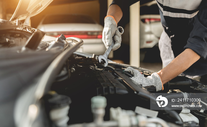 Automobile mechanic repairman hands repairing a car engine automotive workshop with a wrench, car service and maintenance,Repair service.