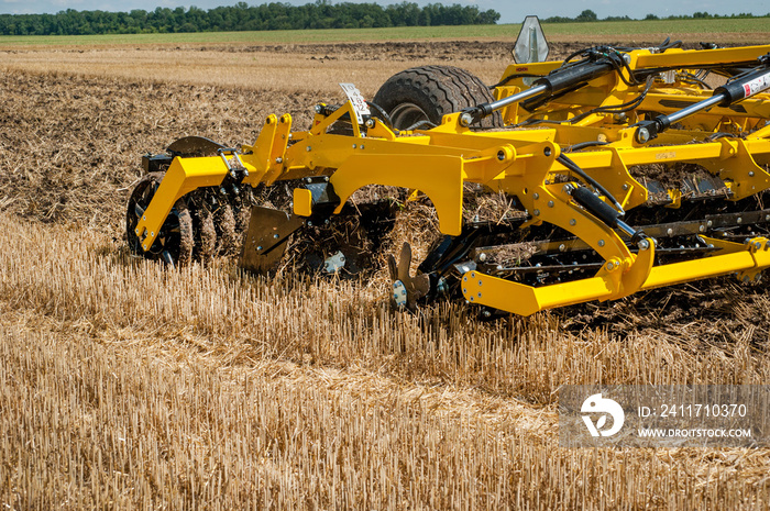 cultivator at work, close up of a disc harrow on a field background