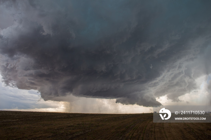 A supercell thunderstorm develops a wall cloud and begins to rotate over the plains of eastern Colorado.