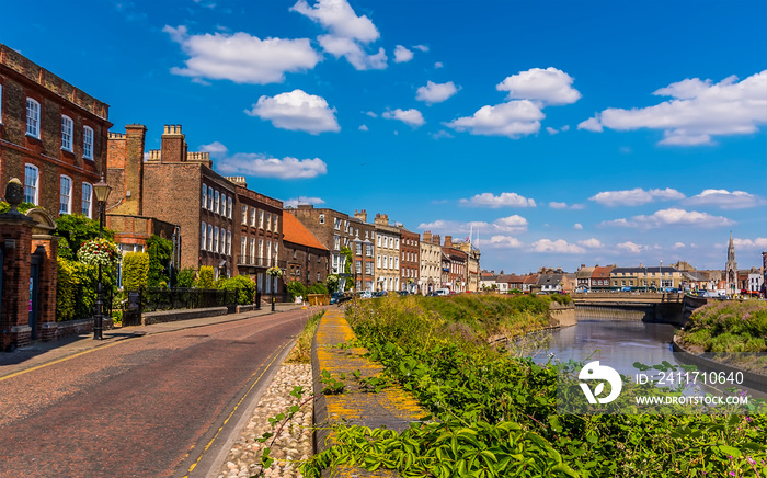 A parade of Georgian buildings on the North Brink beside the River Nene in Wisbech, Cambridgeshire in the summertime