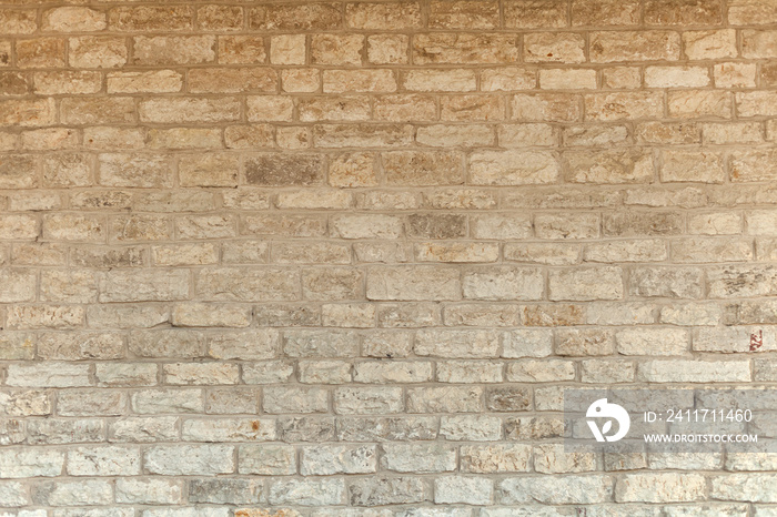 Cream and white brick wall texture background. Brickwork or stonework flooring interior rock old pattern stone design stack. limestone natural briks wall