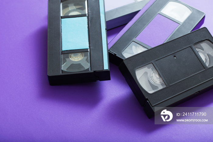 Video cassette on violet background.