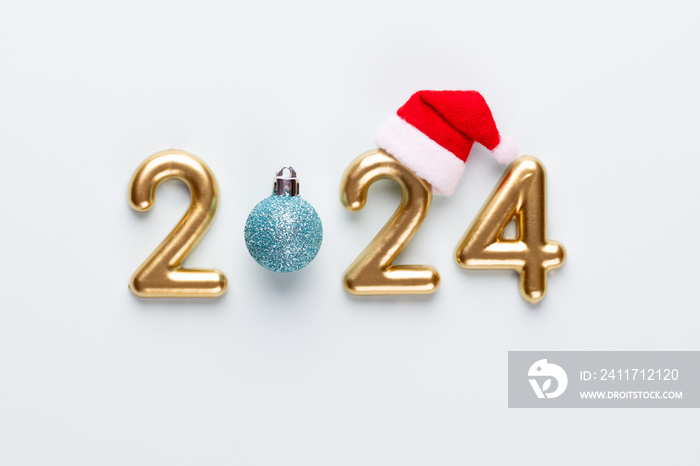 New year 2024 number, golden digits and santa hat over blue background.