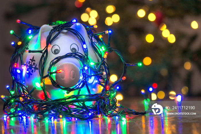 Piggy bank wrapped in Christmas string lights