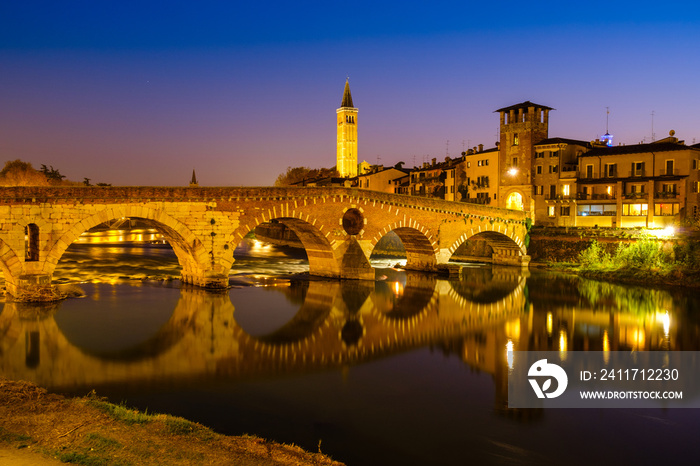 The Ponte Pietra has the Adige River at night