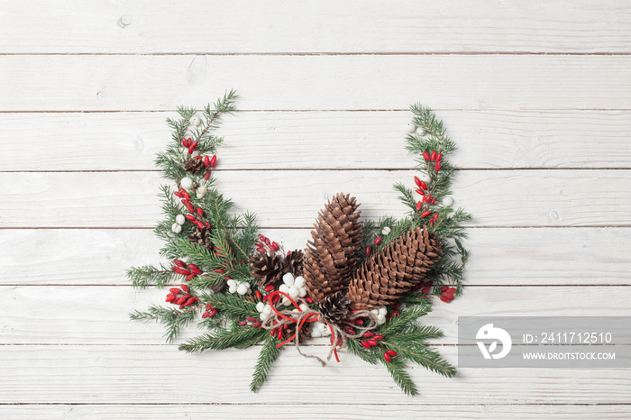 Christmas wreath on white wooden backdrop