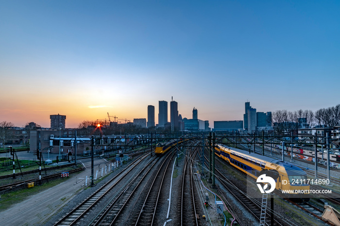 The Hague (Den Haag in Dutch) skyline during the sunset moment behind the train station