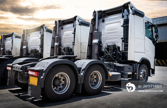 Semi Trailer Trucks The Parking Lot with Sunset Sky. Distribution Warehouse. Shipping Trucks. Diesel Truck Lorry Tractor. Industry Freight Truck Logistics Cargo Transport.