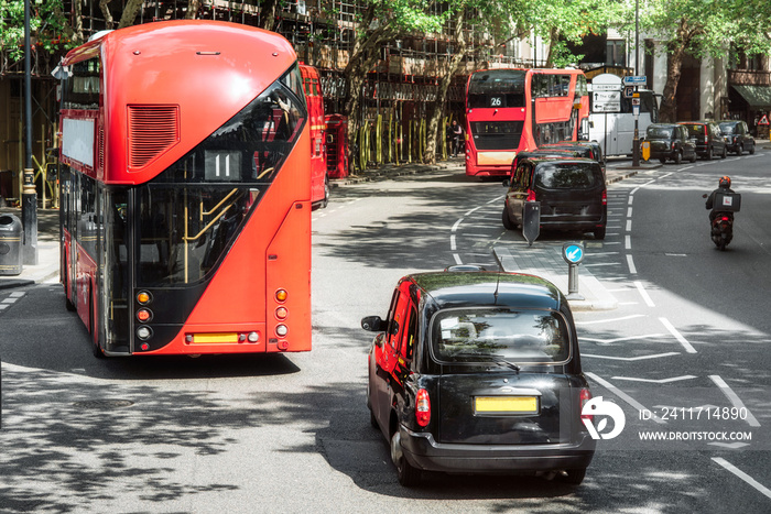 London road traffic, double decker buses and traditional taxi, traditional vehicles of London city .