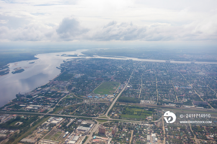 View from above. The border city of Blagoveshchensk from an airplane window. A bridge over the Amur River, connecting Russia and China.