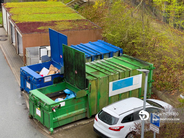 trash compactor for cardboard and a trash compactor for residual waste stand next to each other