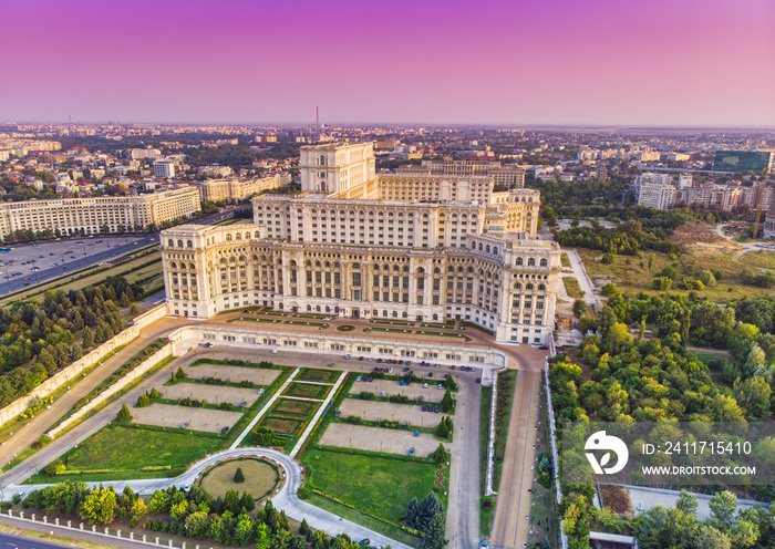 Parliament building or People’s House in Bucharest city. Aerial view at sunset with abstract pink sky