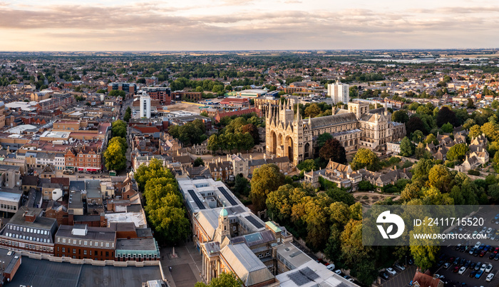 An aerial cityscape of Peterborough Cathedral and town centre at sunset