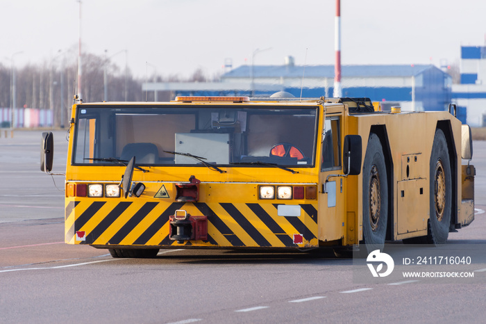 Towing vehicles rides on the apron of the airport.