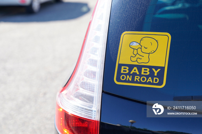 baby on board  warning sign text on rear windows car in street