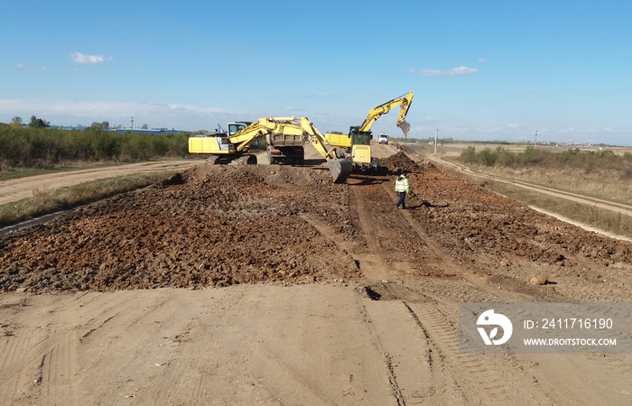 Excavators and truck on construction site