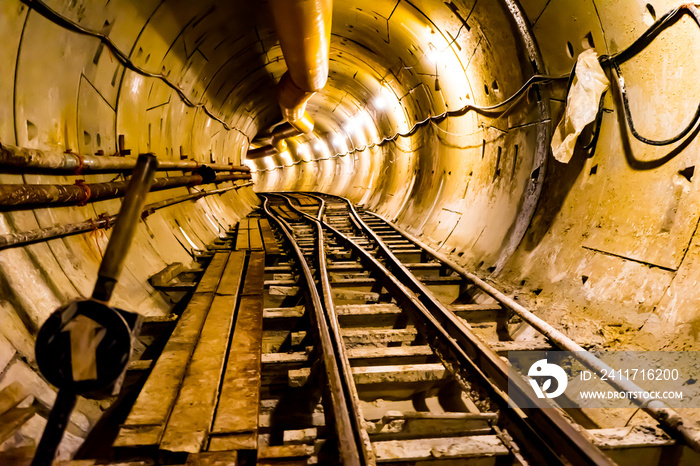 Soft focus of Underground tunnel construction.Transport pipeline by Tunnel Boring Machine for electric train subway with lighting.