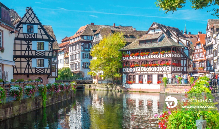 Typical house near water and flowers from La Petite France in Strasbourg, Alsace, France