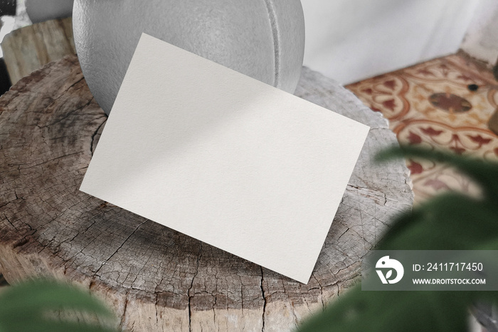 Clean minimal A5 flyer mockup floating on timber background with leaves