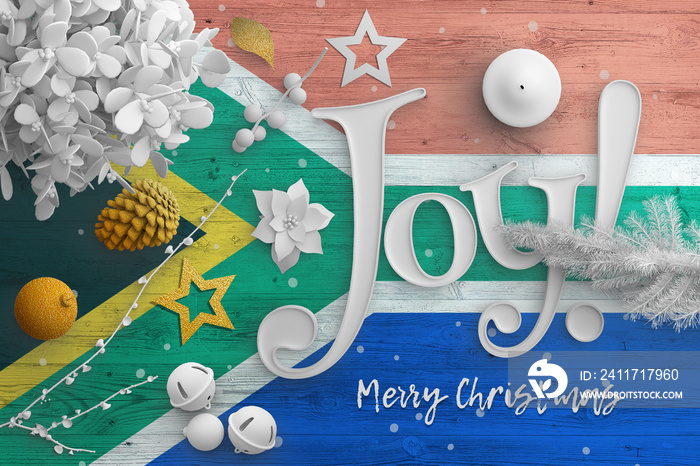 South Africa flag on wooden table with joy text. Christmas and new year background, celebration national concept with white decor.