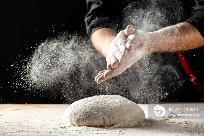 Photo of flour and men hands with flour splash. Cooking bread. Kneading the Dough. Isolated on dark background. Empty space for text