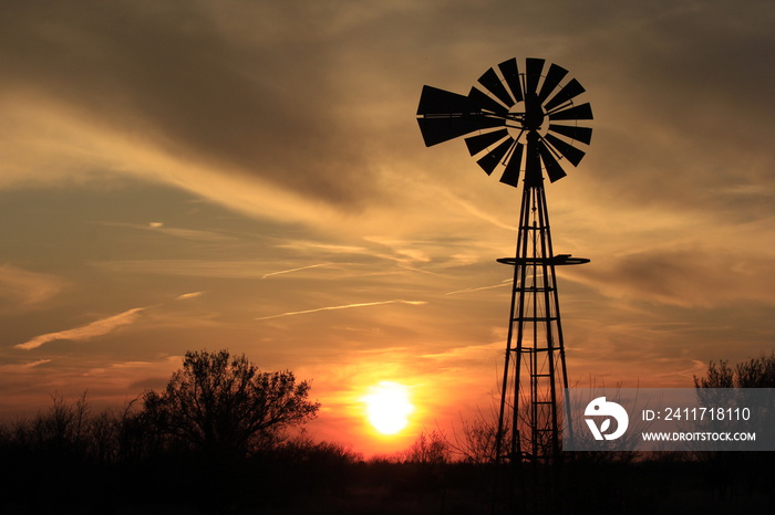 Kansas Windmill Silhouette at Sunset with clouds