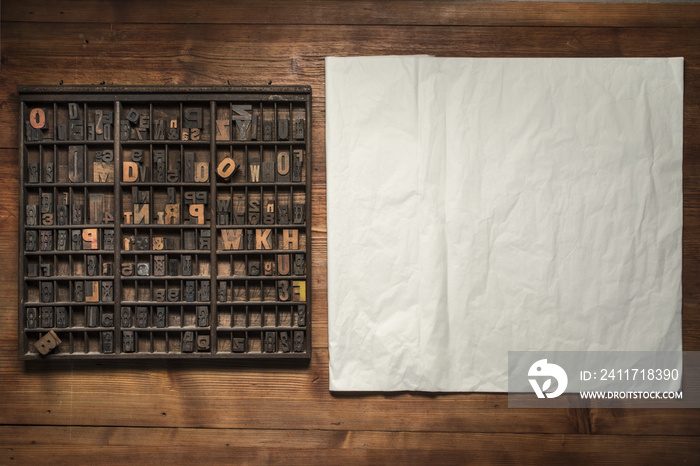 print still life with lettering, brushes and other tools on a wooden background