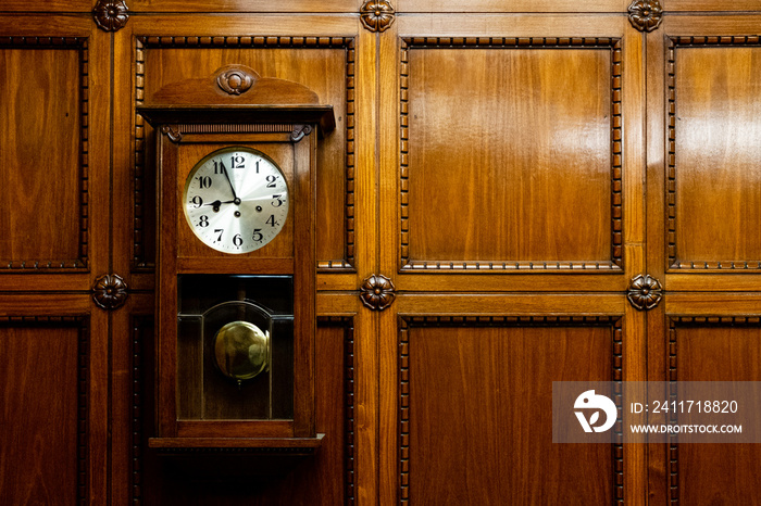 Grandfather clock in wooden case. wood Background. Pendulum wall clock.