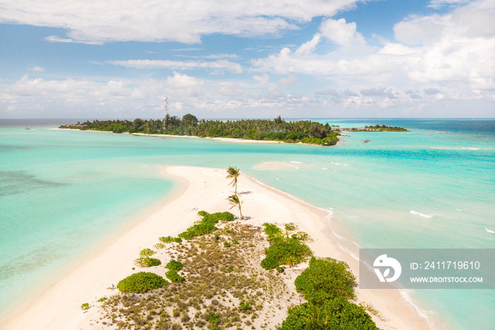 Picture perfect beach and turquoise lagoon on small tropical island on Maldives.