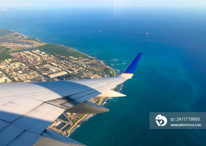 Sky and city view from airplane window. Aerial view of pacific ocean in hawaii