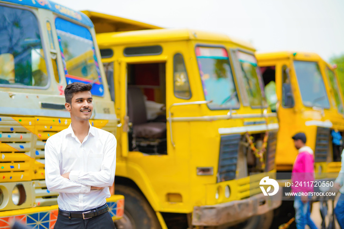 Young indian businessman with his freight forward lorry or truck.