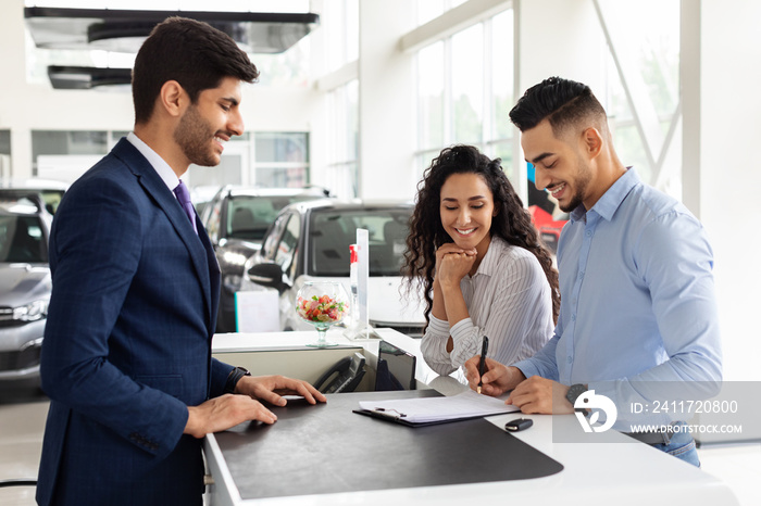 Wealthy arab family buying new car in showroom